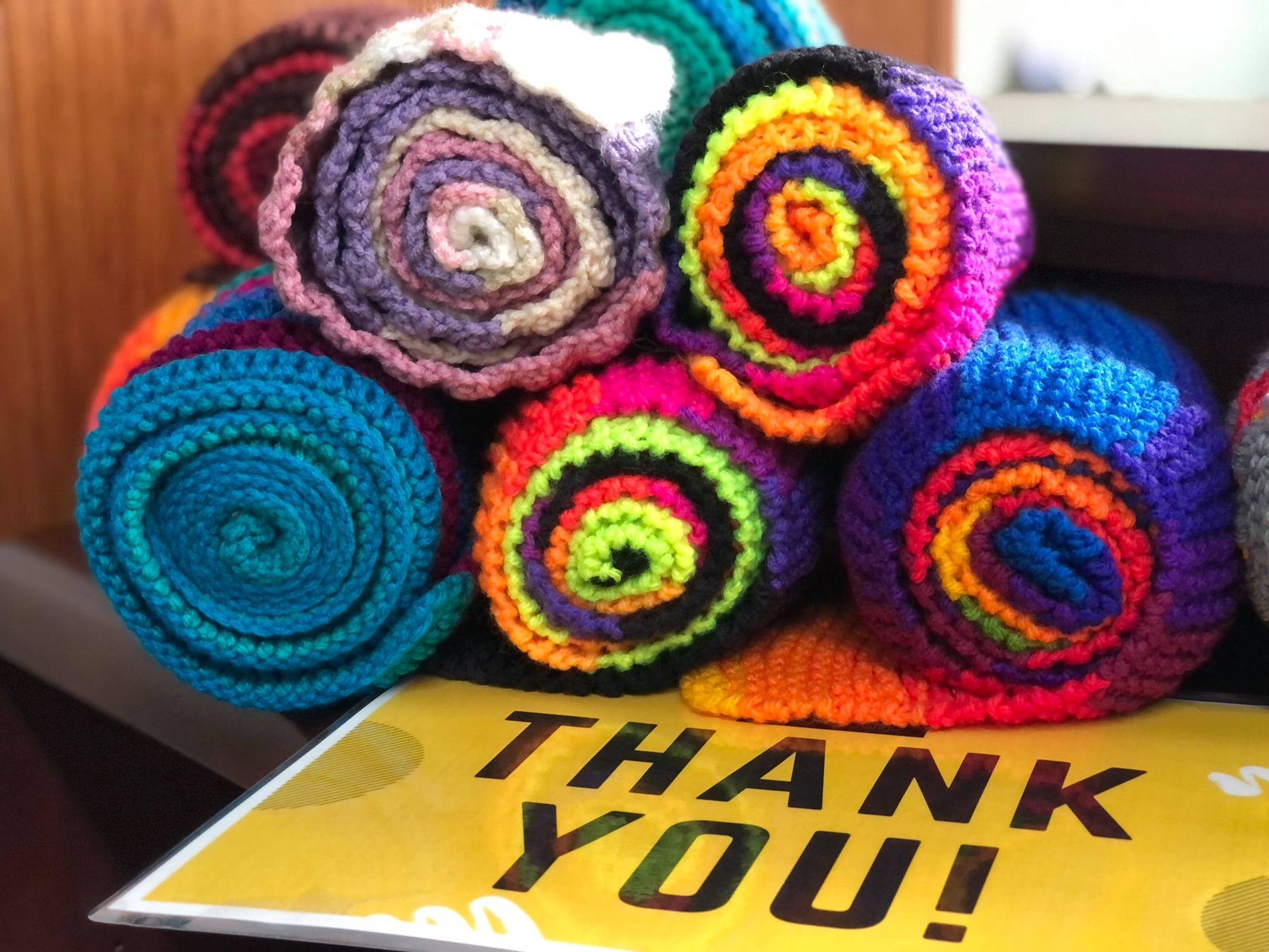 Colorful scarves rolled with a Thank you note